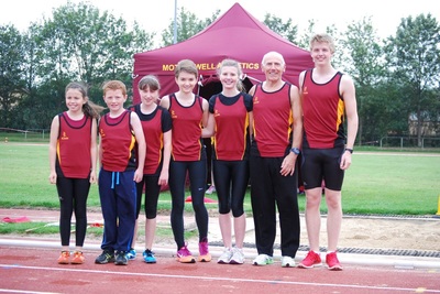 Motherwell athletics team members in front of their folding gazebo